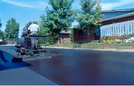 A contractor using our asphalt products in Denver, CO